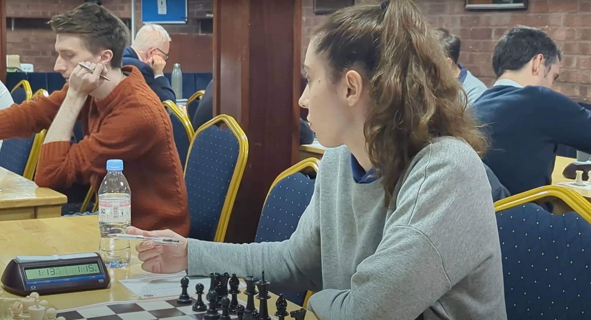 A chess player prepares for her game.